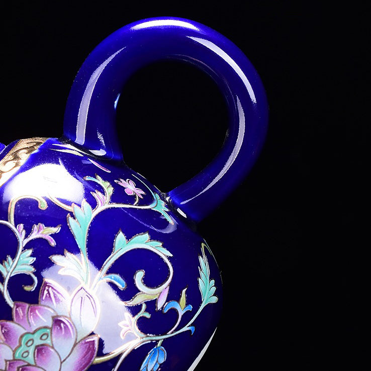 Elegant porcelain tea set with hand-painted enamel designs and tea cups