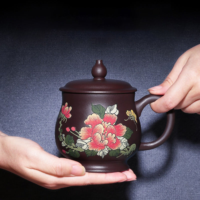 Close-up of handcrafted purple clay teacup with peony design, showcasing detailed artwork