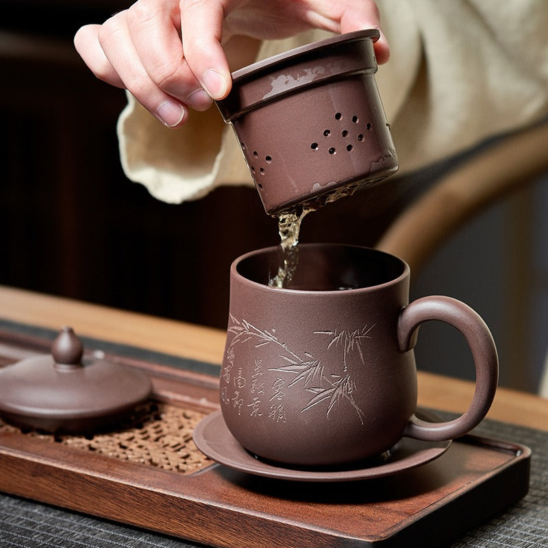 Side angle of the Premium Yixing Handmade Tea Cup with infuser, highlighting its unique bamboo design.
