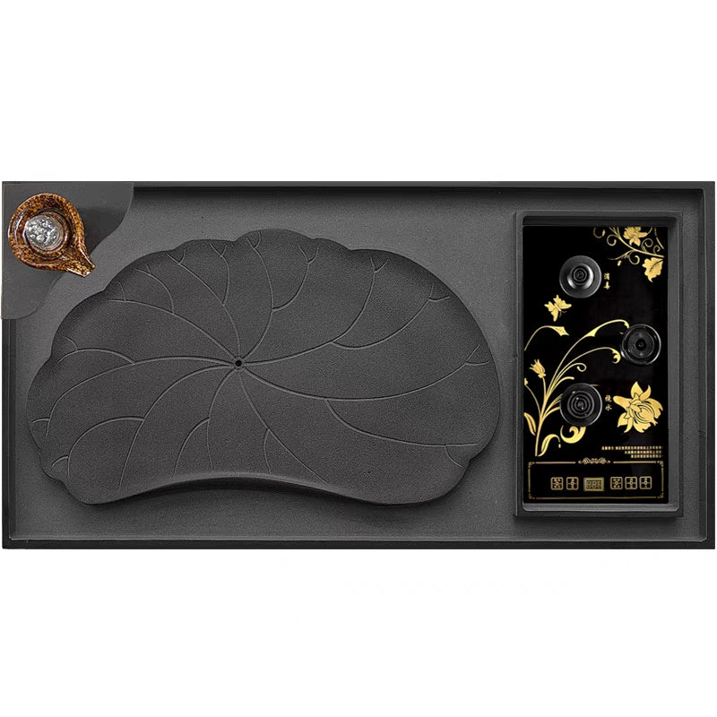 Tea set on black stone lotus pond tea tray during a traditional Chinese tea ceremony
