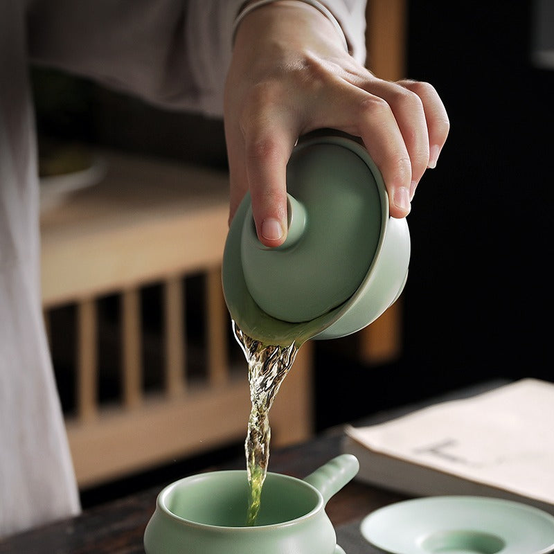 Using the gaiwan to brew tea, showing pouring technique