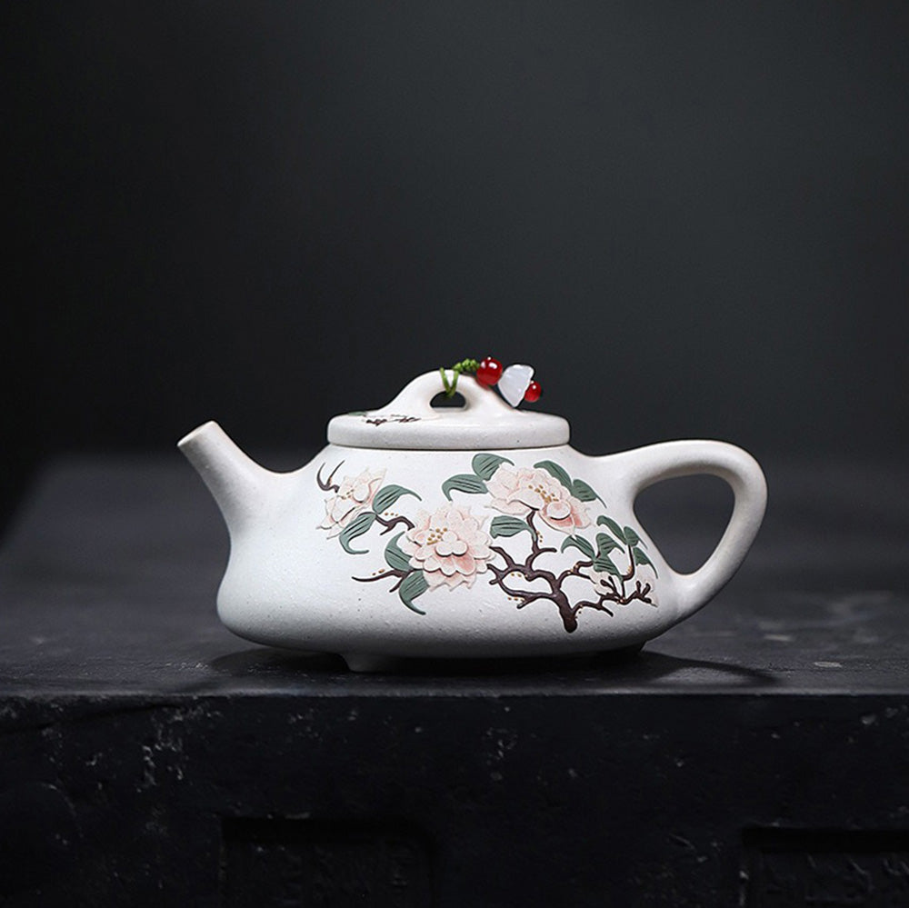 Front view of white clay peony Yixing teapot with intricate hand-painted design