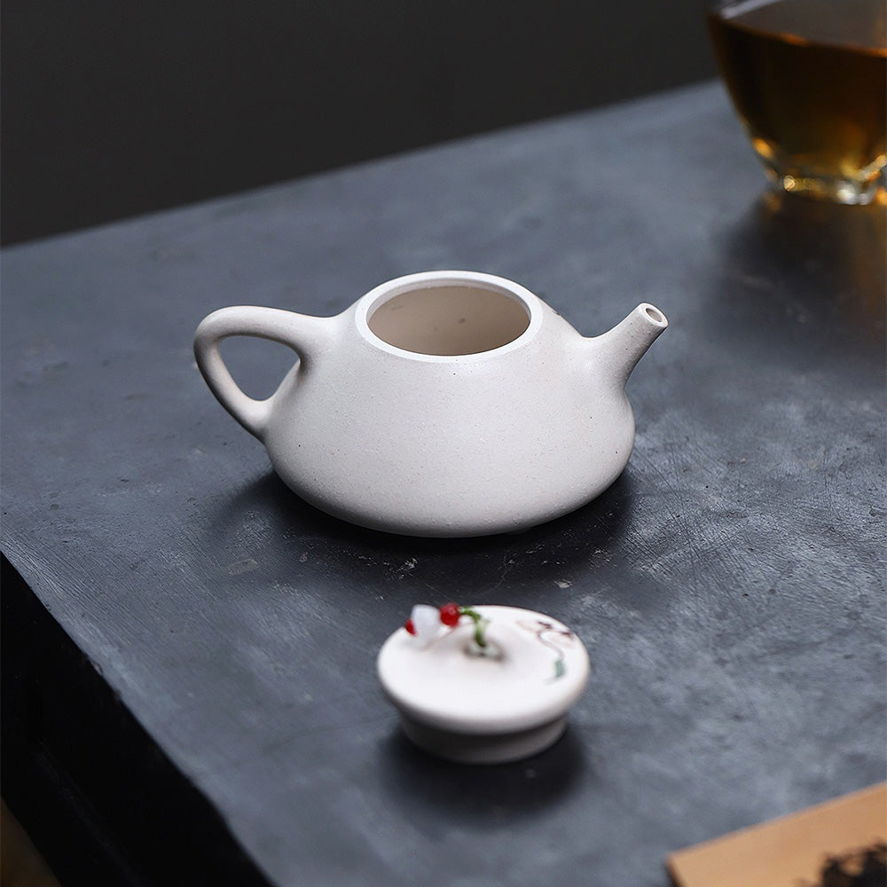 Close-up of the purple clay teapots spout and handle, showcasing craftsmanship