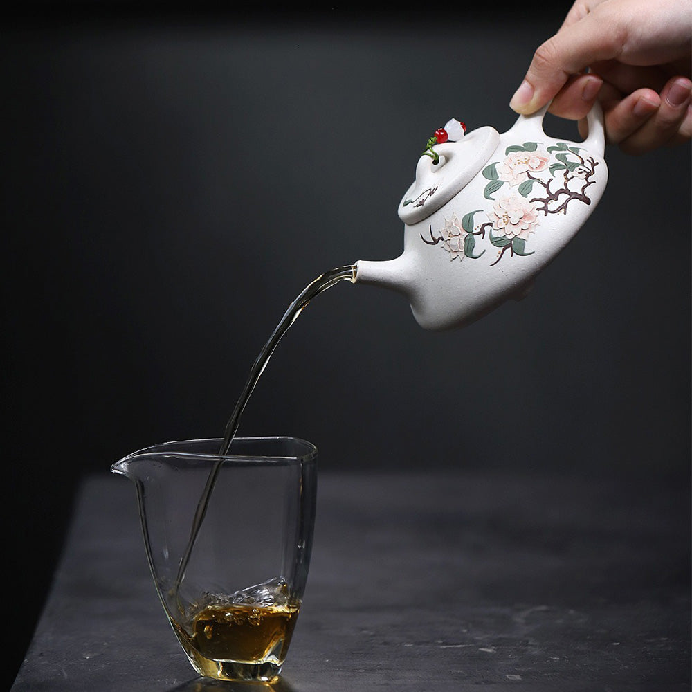Front view of white clay peony Yixing teapot with intricate hand-painted design