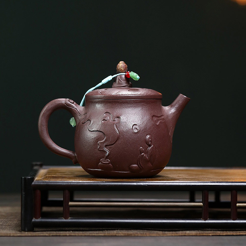 Close-up view of the purple clay Buddha teapot, highlighting its smooth finish and intricate details.