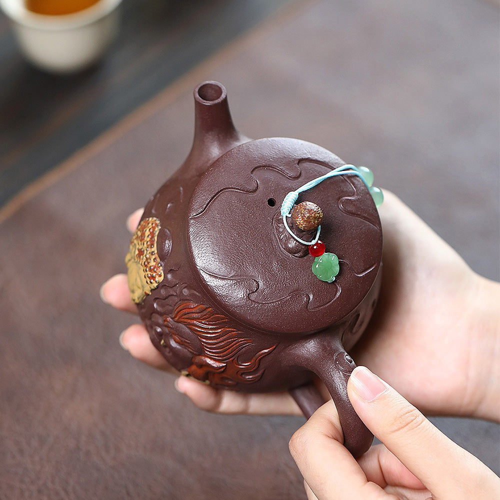 Elegant Hanwa purple clay teapot with Buddha relief, showcasing a unique artistic design.