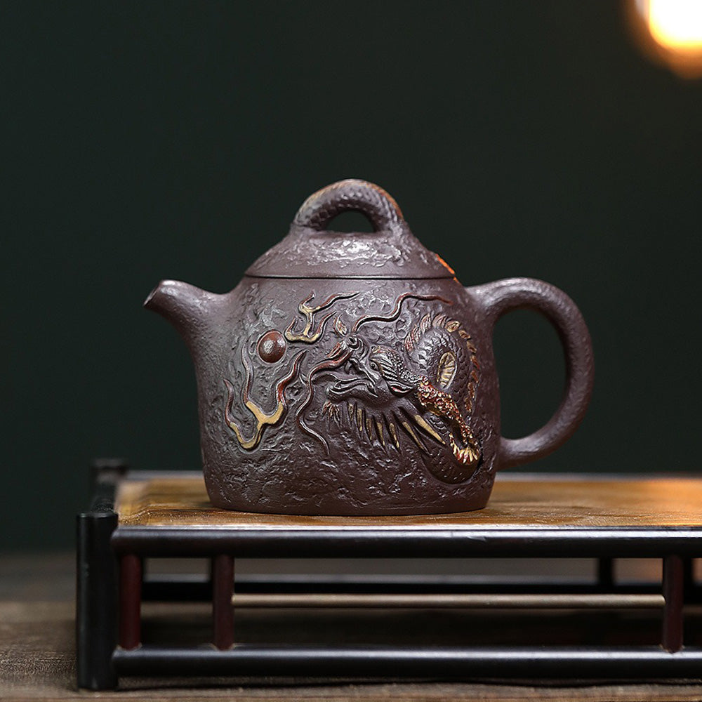 Side view of the purple clay dragon teapot showing intricate engravings