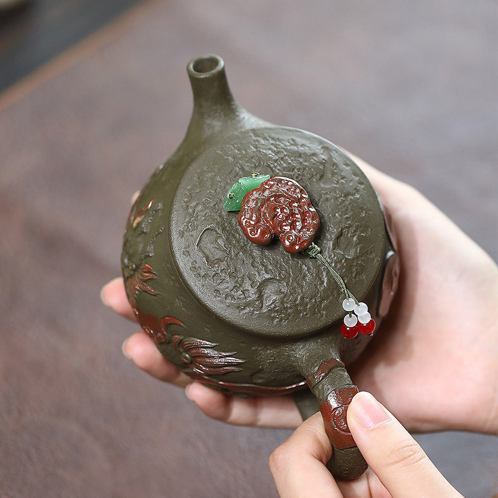 Close-up of Hanwa dark green clay teapot with dragon design, showcasing detailed craftsmanship