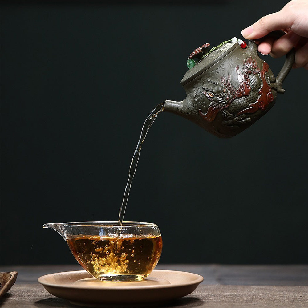 Close-up of Hanwa dark green clay teapot with dragon design, showcasing detailed craftsmanship