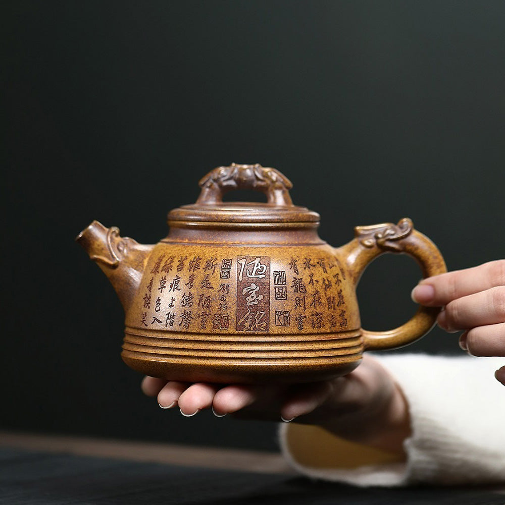Close-up of dragon carvings on the Yixing teapot handle and spout