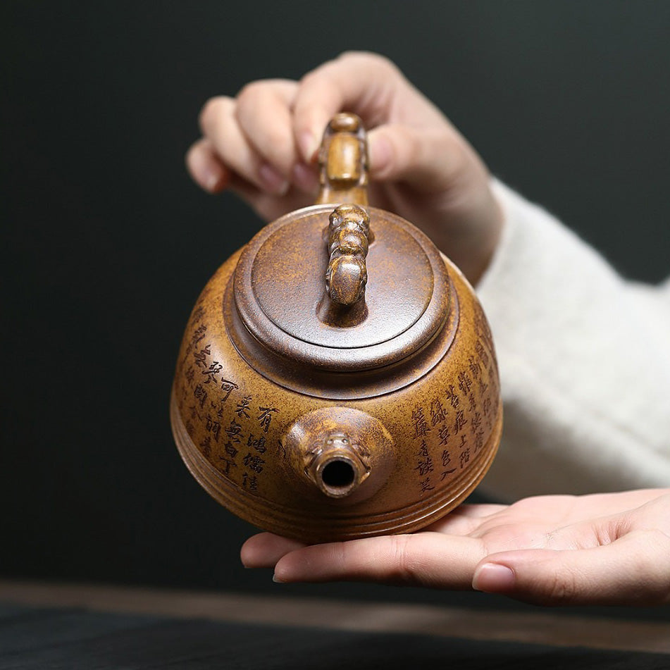 Elegant Yixing double dragon teapot on a wooden surface, showcasing detailed craftsmanship