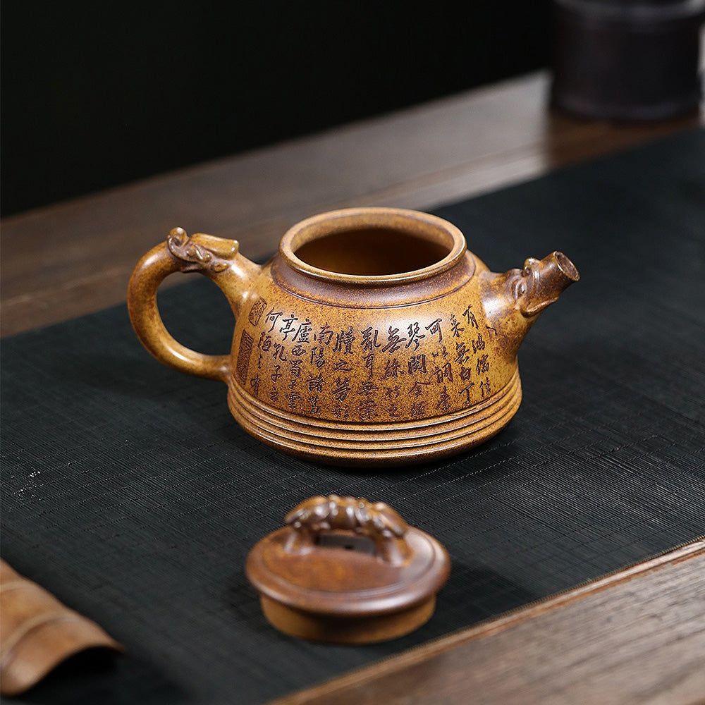 Close-up of dragon carvings on the Yixing teapot handle and spout