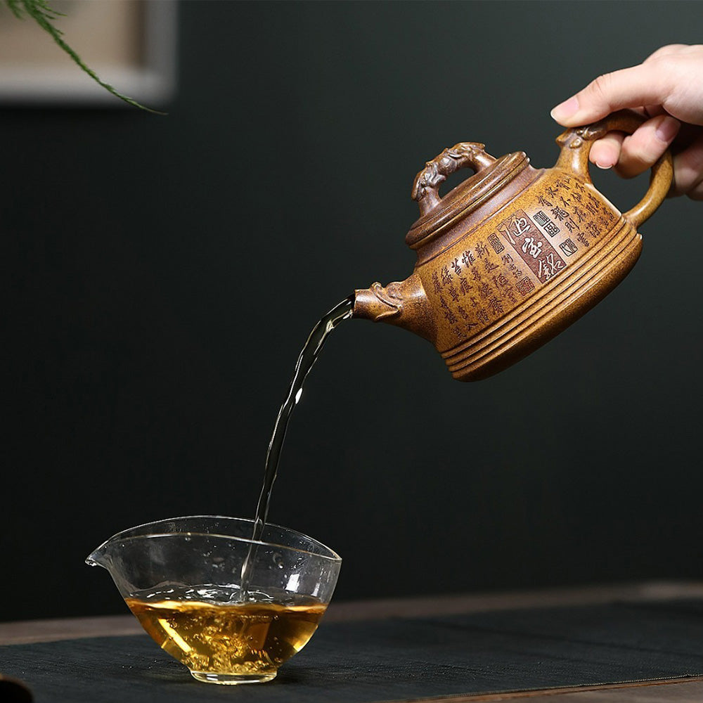 Elegant Yixing double dragon teapot on a wooden surface, showcasing detailed craftsmanship