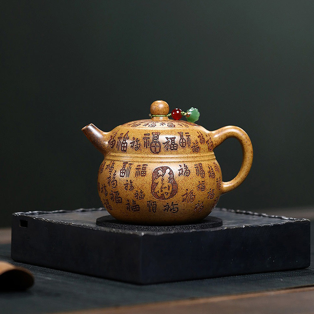 Close-up of the dragon bone gold sand clay teapot showing its golden luster and gourd shape