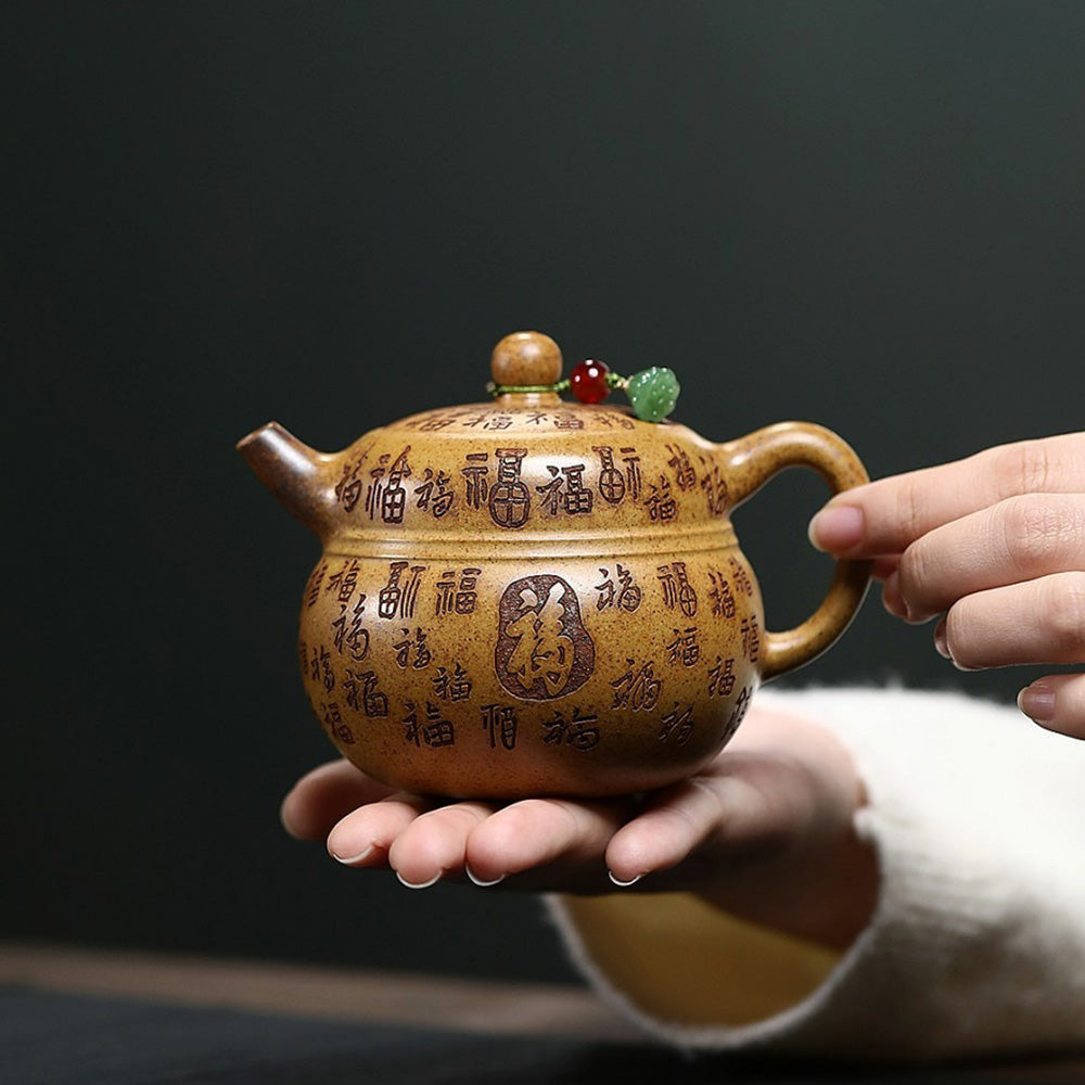 Side view of the Yixing teapot with detailed engravings and comfortable handle