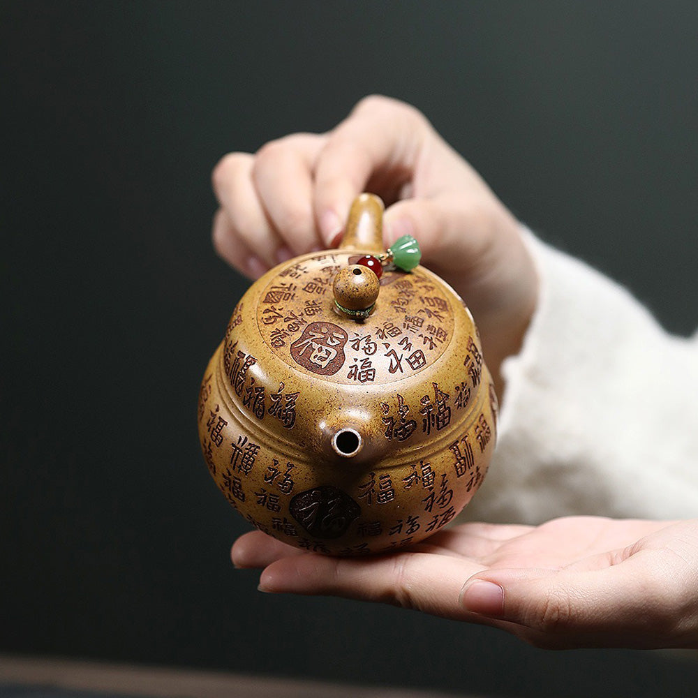 Close-up of the dragon bone gold sand clay teapot showing its golden luster and gourd shape