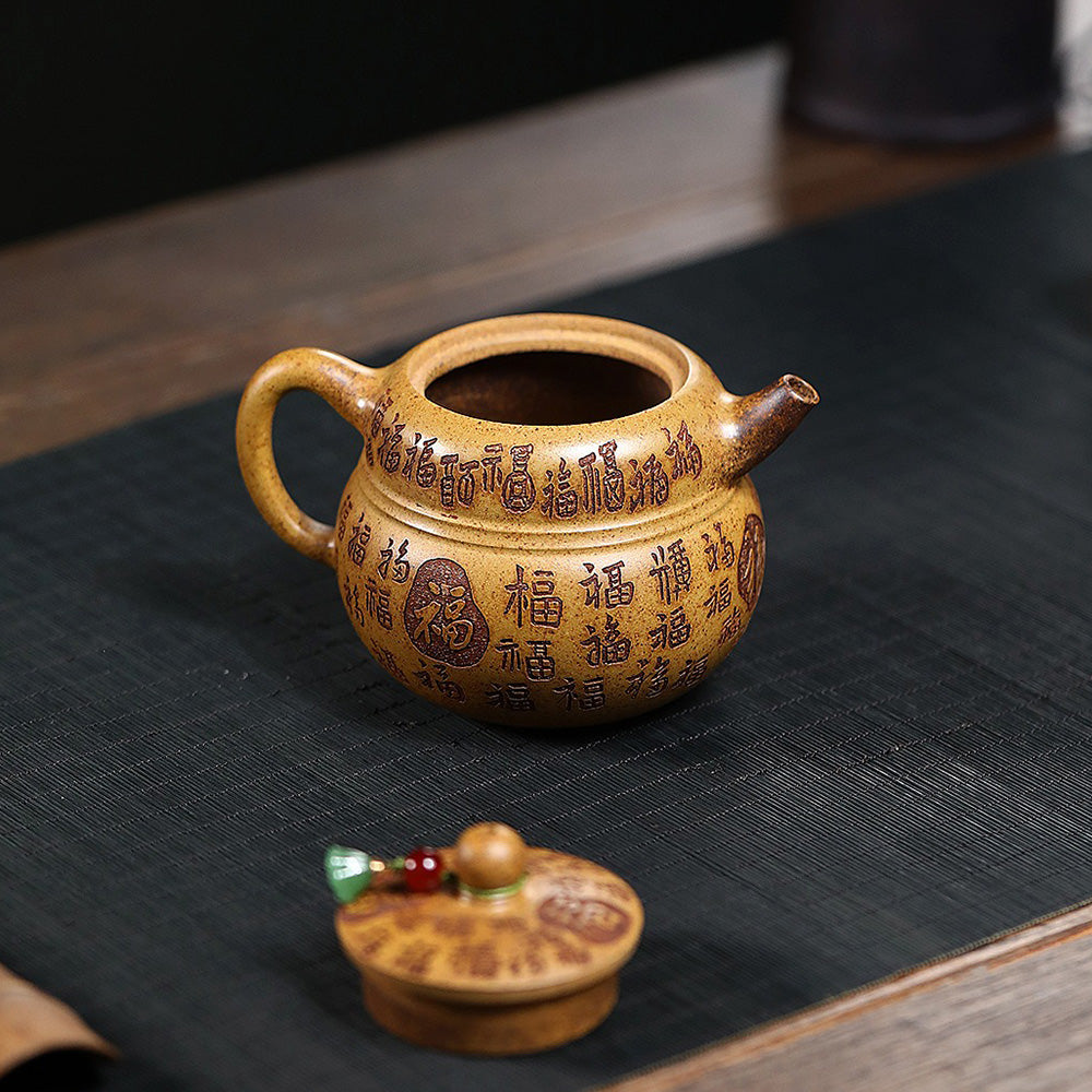 Side view of the Yixing teapot with detailed engravings and comfortable handle