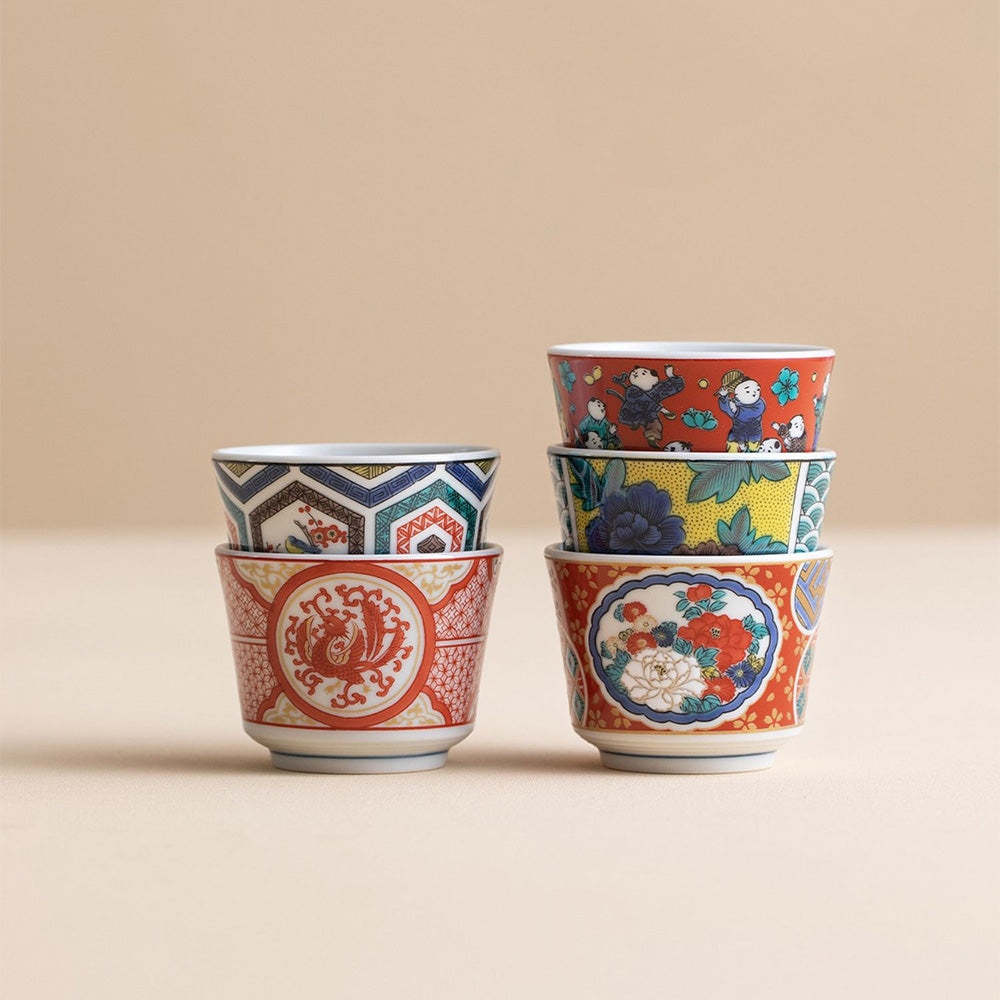 Five Japanese tea cups displayed in decorative gift box against a minimal backdrop
