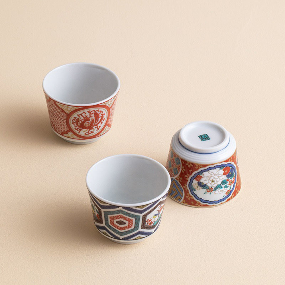 Angled top-down view of Kutaniyaki tea cups showing intricate patterns and glaze