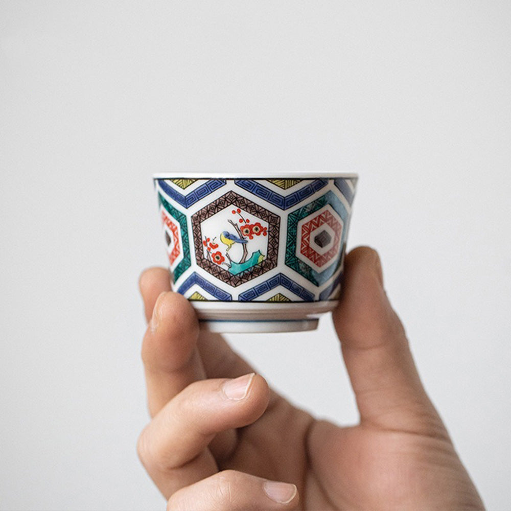 Five Japanese tea cups displayed in decorative gift box against a minimal backdrop