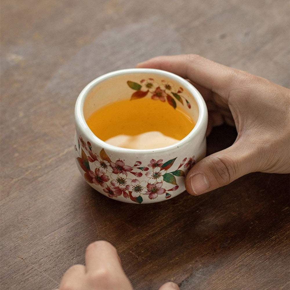 Close-up of a spring flower tea cup from the Mino-yaki set, showcasing the delicate glaze.
