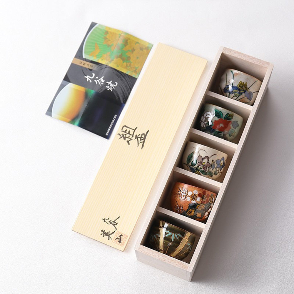 A beautifully arranged Kutani tea cup set with a tea serving, highlighting its artistic details.