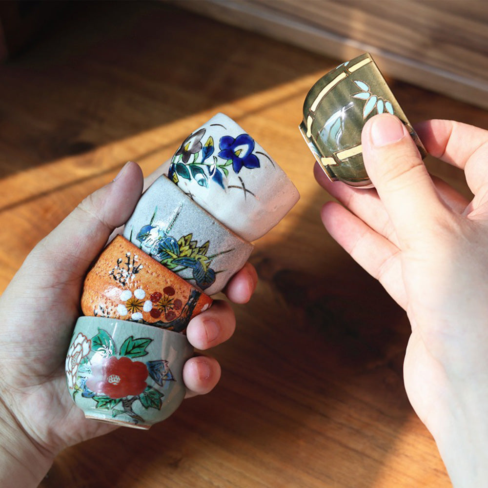 Close-up of the hand-painted Kutani tea cups showcasing intricate floral designs.
