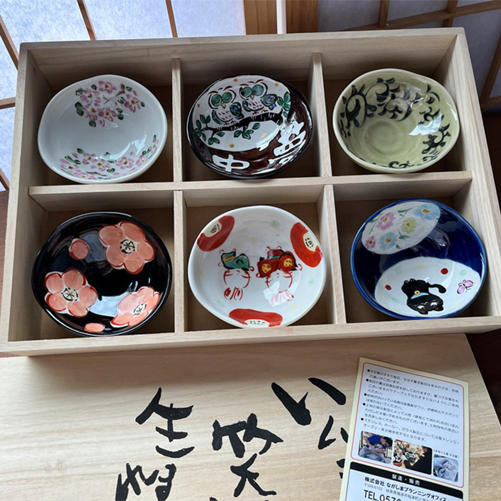 Elegant Japanese Mino ware bowls displayed with snacks and sauces.