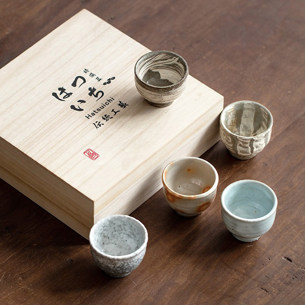 Close-up of elegant Wango-yaki tea cups highlighting unique textures and colors.