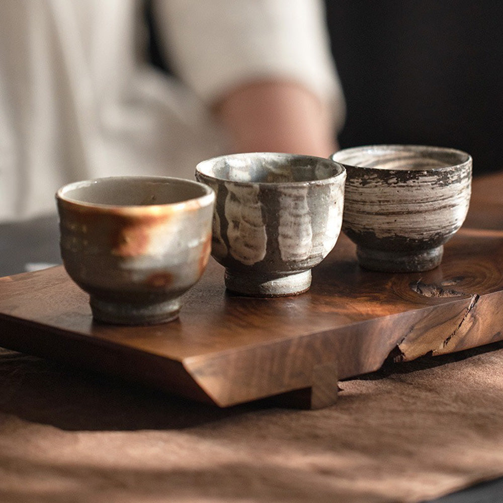 Close-up of elegant Wango-yaki tea cups highlighting unique textures and colors.