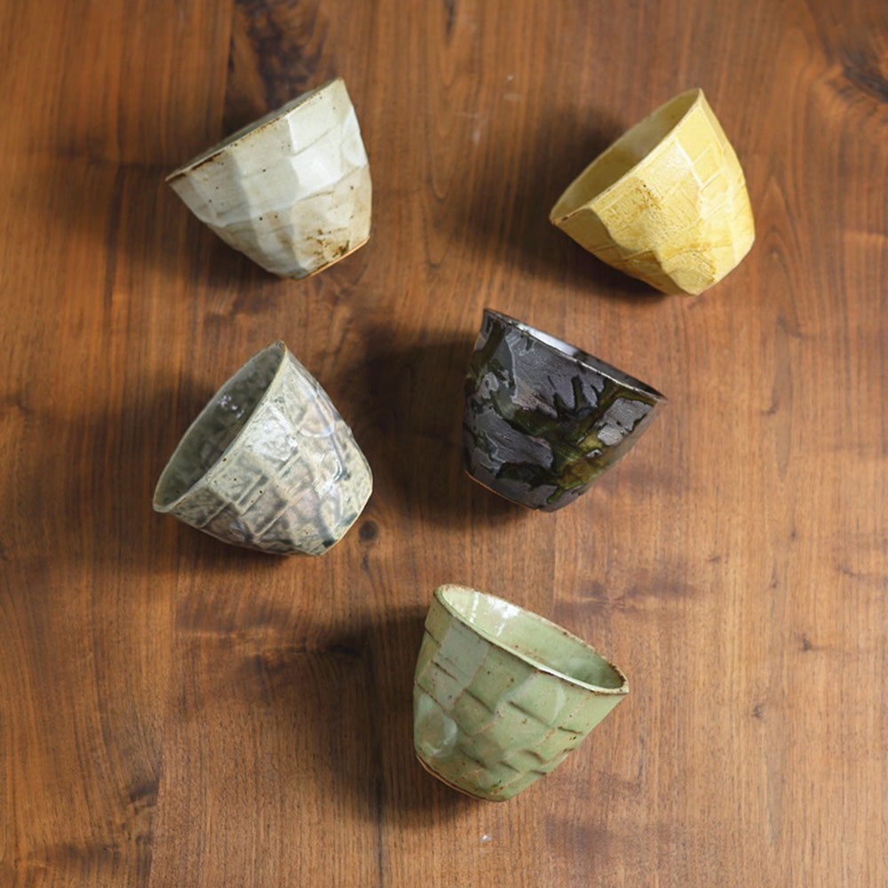 Close-up view of a wabi-sabi ceramic tea cup set with earthy tones.