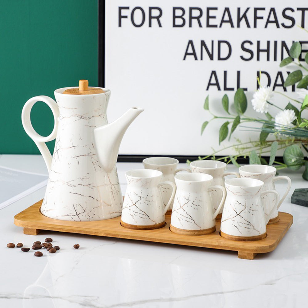 Elegant marble ceramic teapot with bamboo tray, showcasing a modern design.