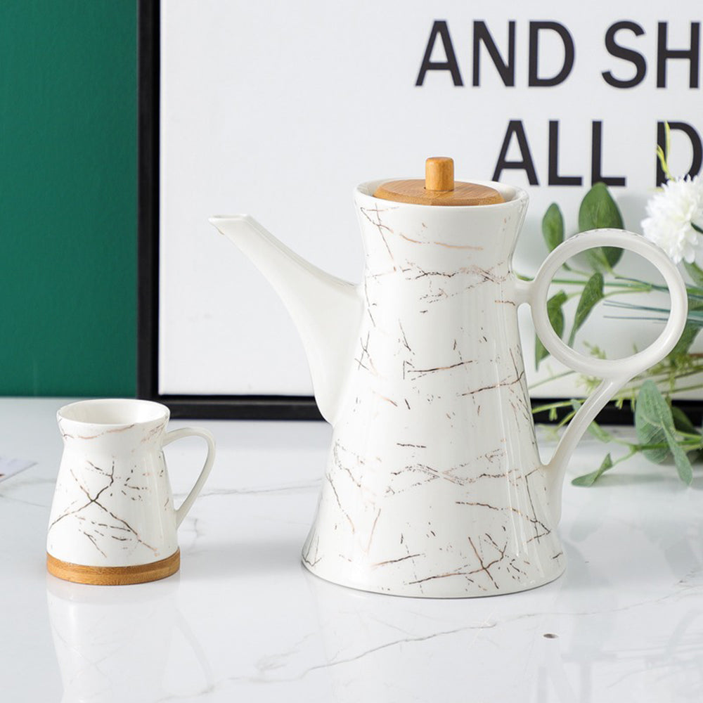 Elegant marble ceramic teapot with bamboo tray, showcasing a modern design.
