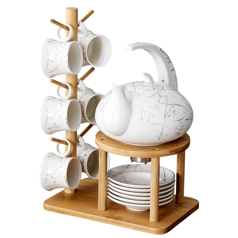 Close-up of marble texture ceramic teapot with bamboo rack for elegant tea serving
