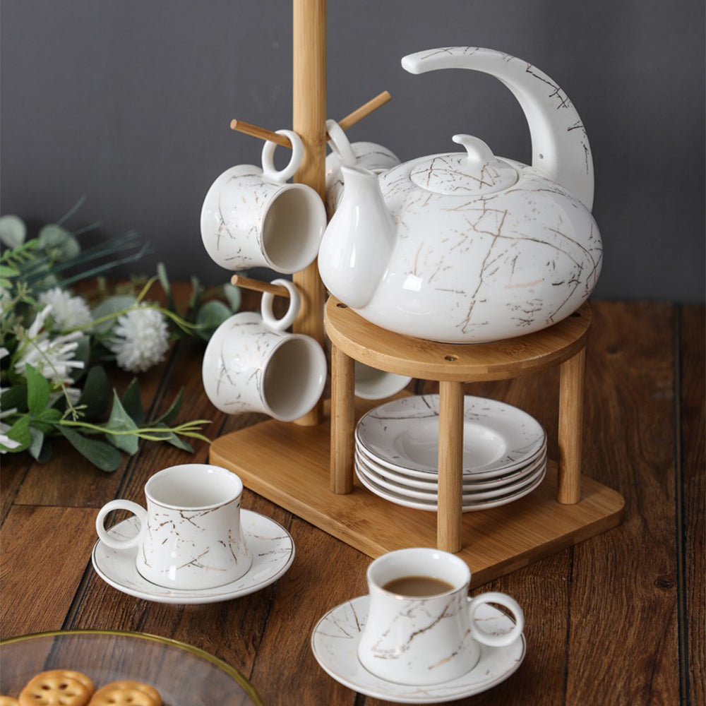 Set of tea cups and saucers arranged on bamboo tea rack, stylish and functional
