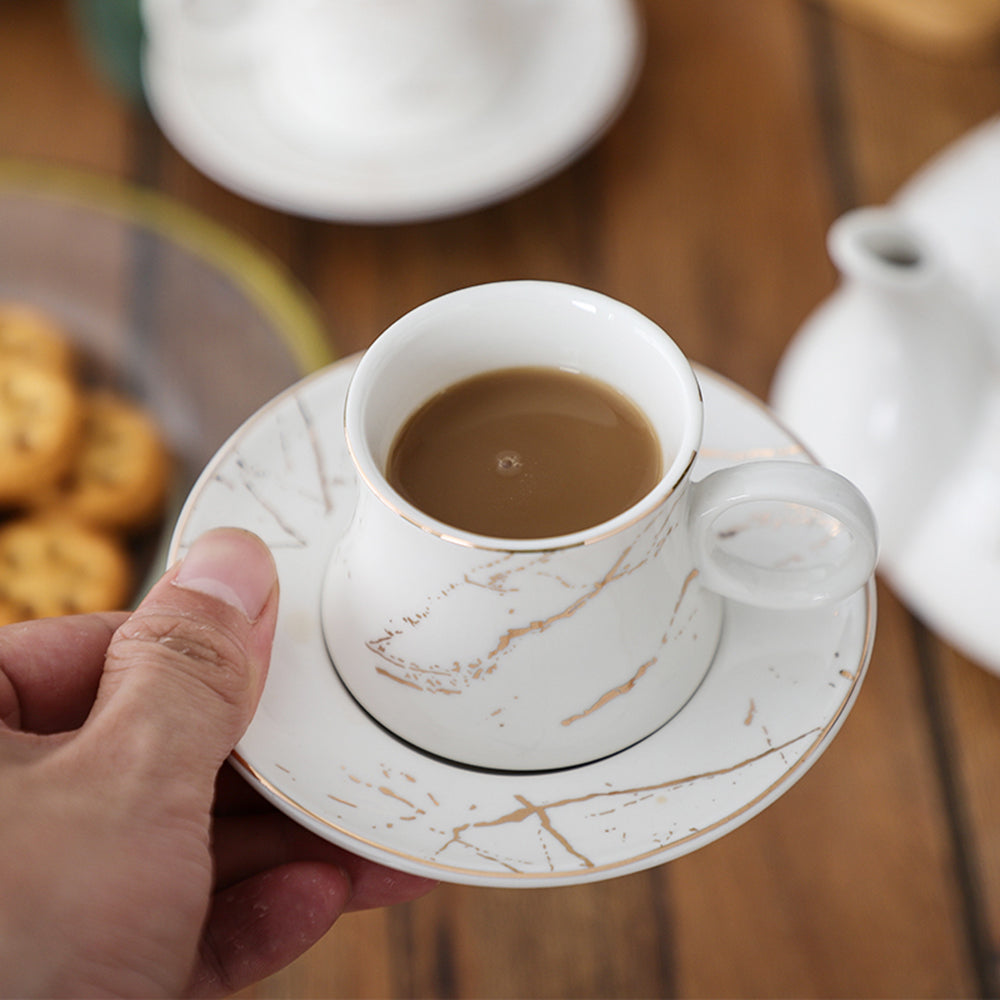 Set of tea cups and saucers arranged on bamboo tea rack, stylish and functional