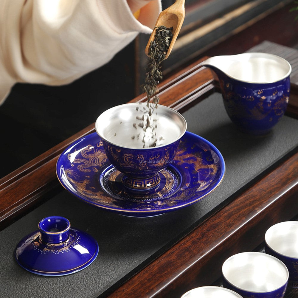Top-down view of the Chinese tea set arranged for a traditional ceremony, showcasing the gold dragon and phoenix design.