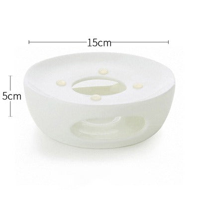 Elegant porcelain teapot warmer showcasing candle design from above.