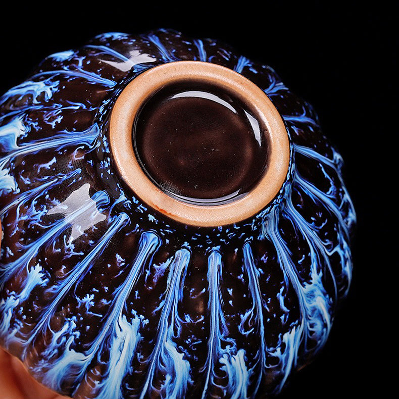 Handmade blue jianzhan gongfu tea cup with sterling silver lid, showcasing detailed craftsmanship