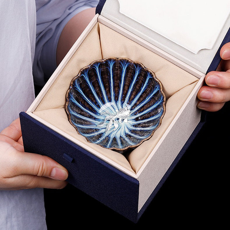 Handmade blue jianzhan gongfu tea cup with sterling silver lid, showcasing detailed craftsmanship