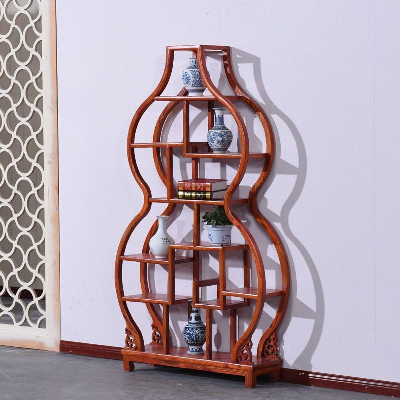 Gourd shaped Chinese curio cabinet showcasing tea sets and collectibles in a stylish living room