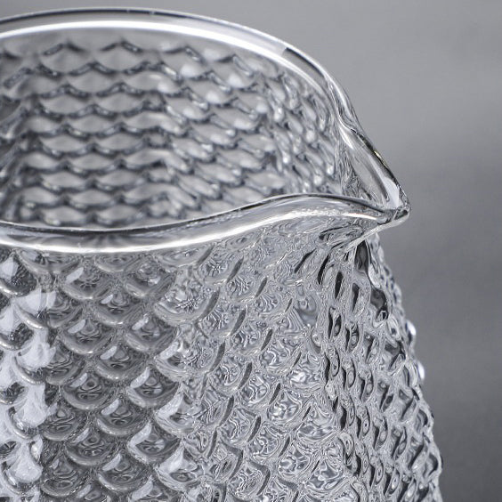 Side view of borosilicate glass teapot with leaf-shaped lid and infuser