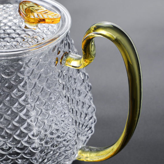 Tea brewing in transparent glass teapot with blooming flower tea