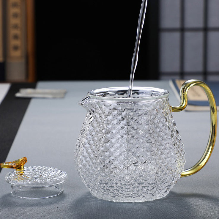 Close-up of colorful handle glass teapot with infuser for flowering tea