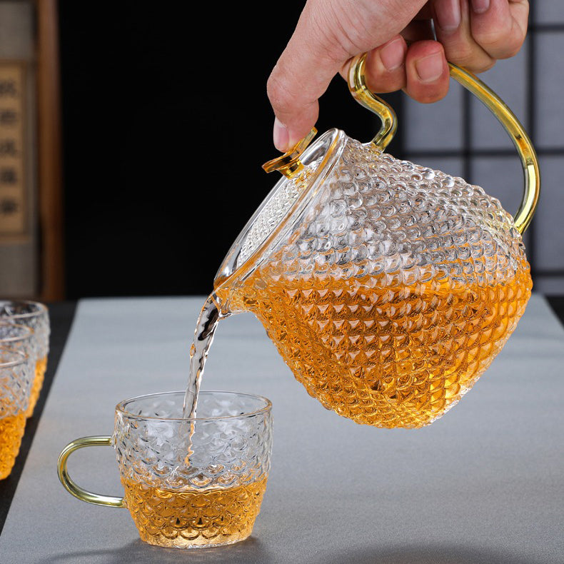 Close-up of colorful handle glass teapot with infuser for flowering tea