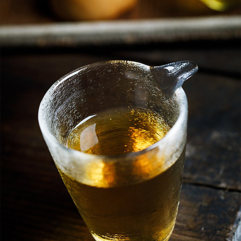 Side angle showing golden rim cup resting beside a teapot