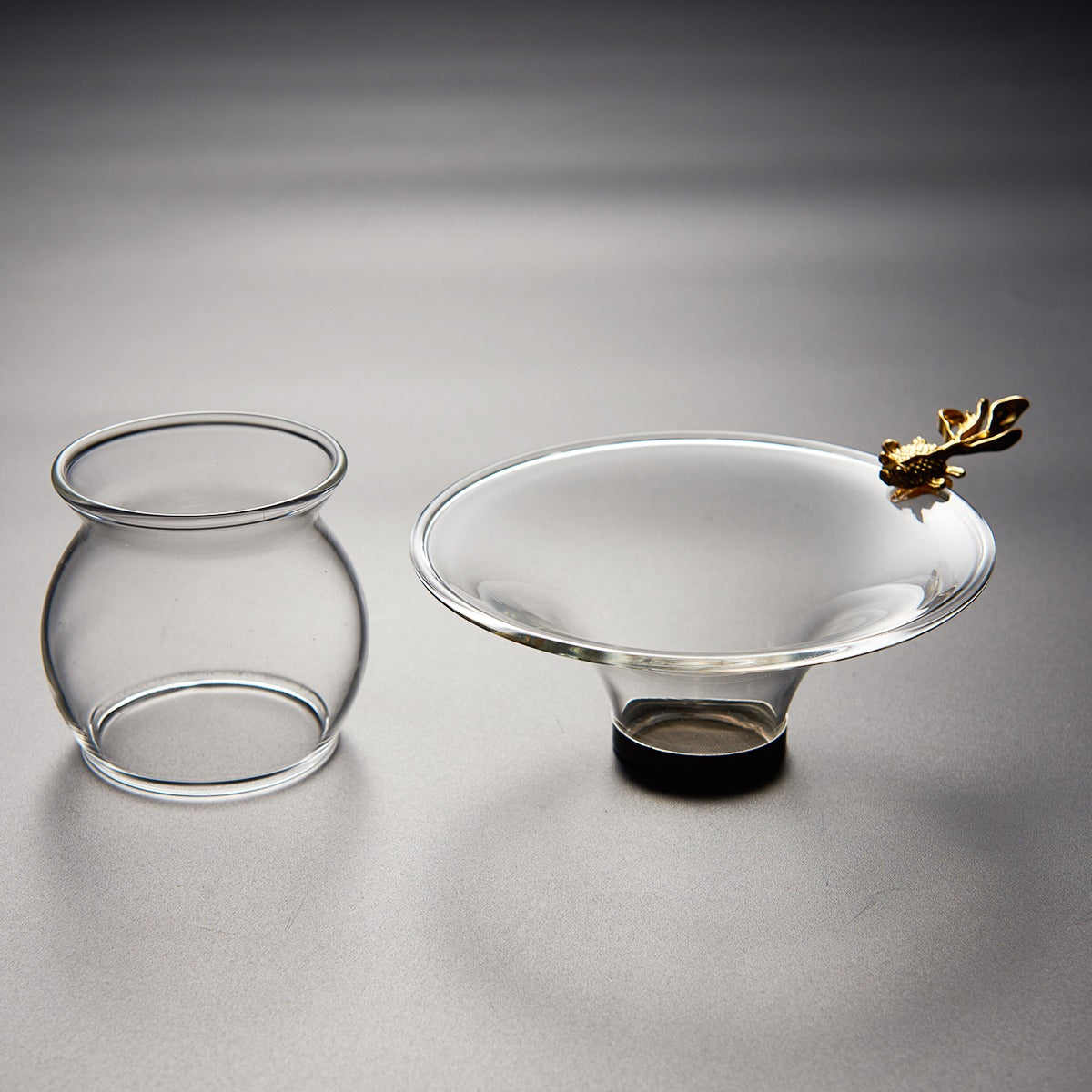 Close-up of the premium tea strainer for brewing showing the detailed goldfish handle and fine filtration mesh.
