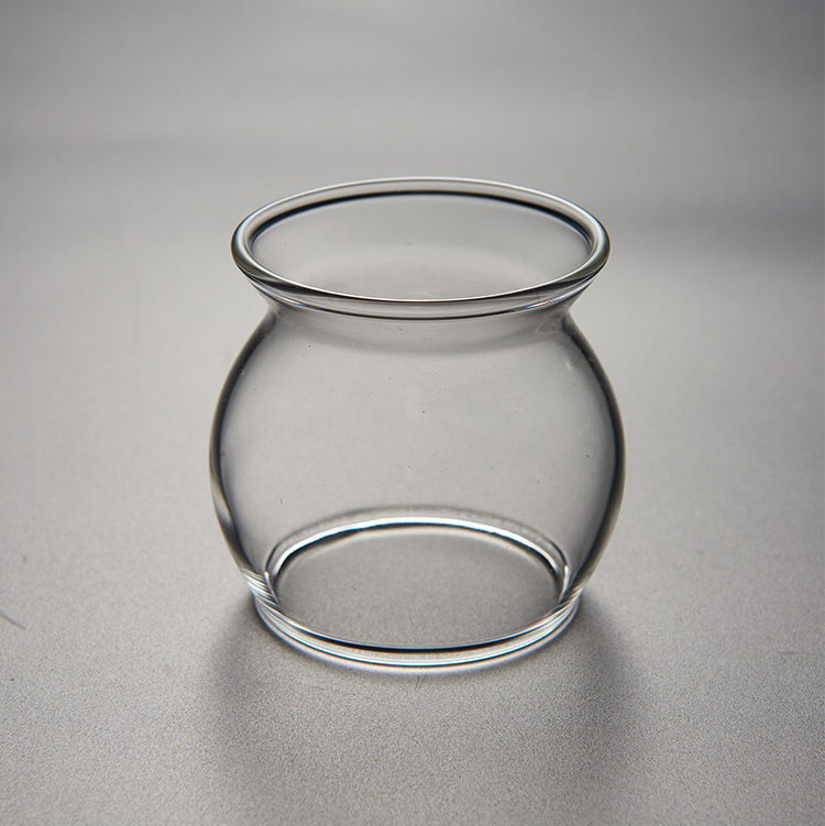 Side angle showing the tea infuser in use with vibrant tea leaves, emphasizing its functional design.