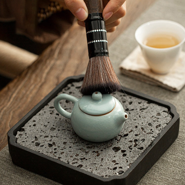 Angled view showing Ice Crack glaze of the ceramic teapot resting on wooden tray