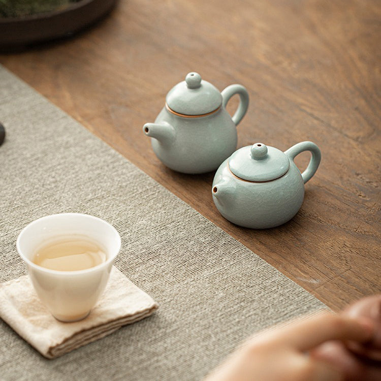 Angled view showing Ice Crack glaze of the ceramic teapot resting on wooden tray